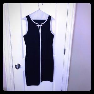 Navy dress. White Trim. Zipper up the back.